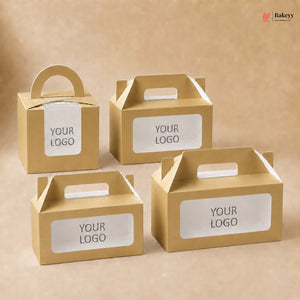 Four gold cardboard boxes with clear window panels and 'YOUR LOGO' text on a beige background.