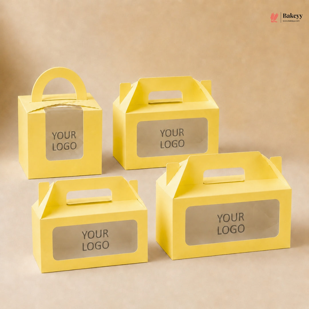 Four yellow cardboard boxes with clear window panels and 'YOUR LOGO' text on a beige background.