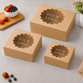 Three brown cardboard boxes with 'YOUR LOGO' printed on them, placed on a light gray surface with berries and a cutting board in the background.