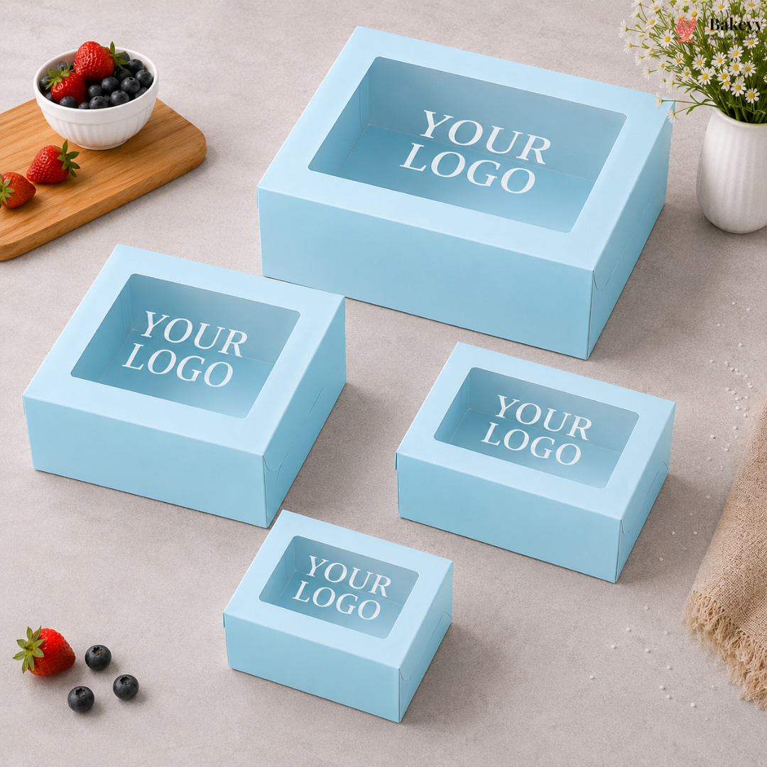 Set of light blue boxes with 'YOUR LOGO' text on a neutral surface with fruits and a plant.