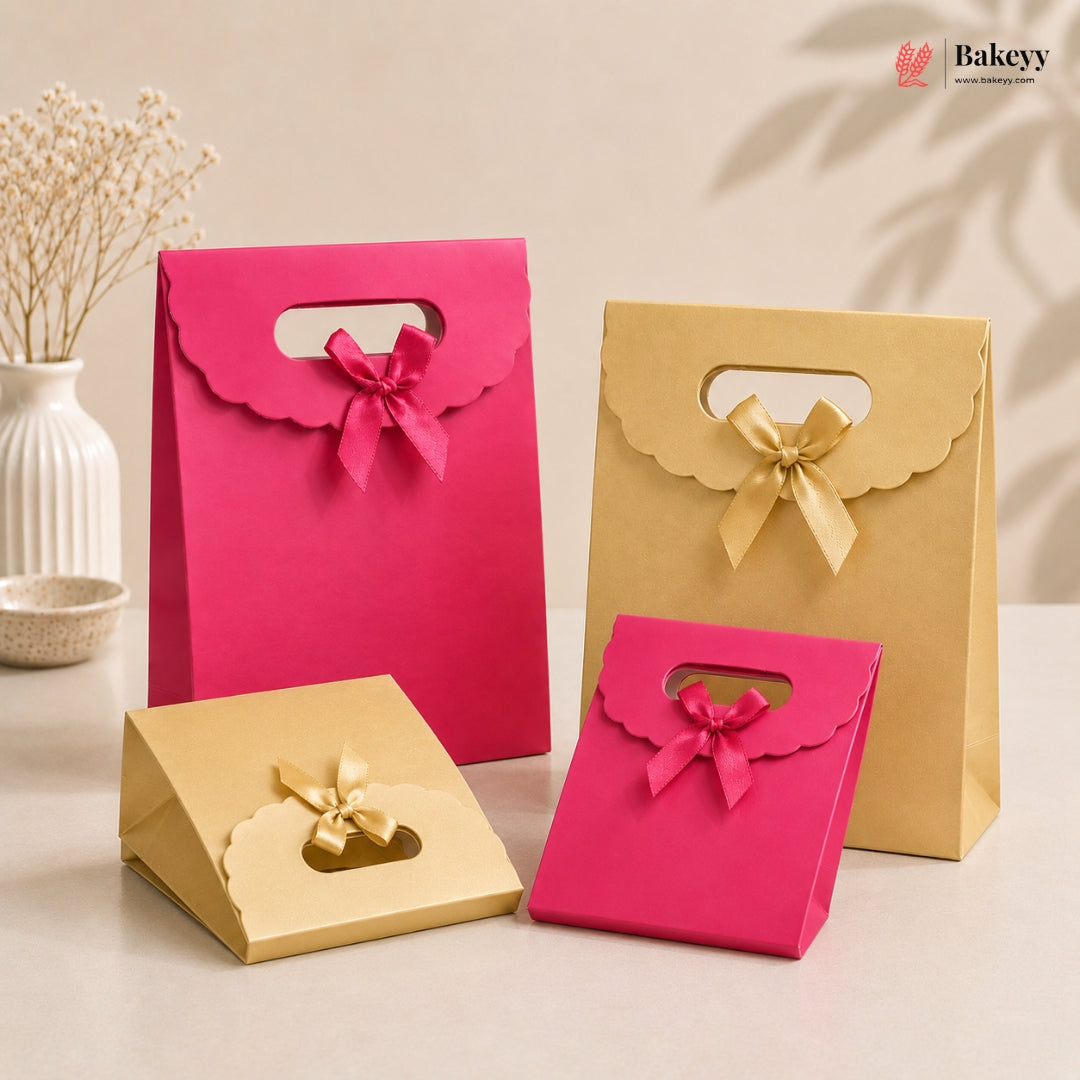 Pink and gold gift boxes with bows on a neutral background