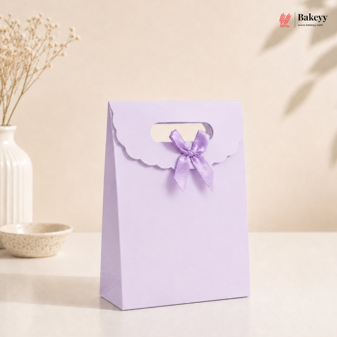 Purple gift bag with a bow on a beige background, featuring the brand 'Bakeey'.