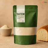 Green package of Datem Dough Conditioner with a background of flour and bread.