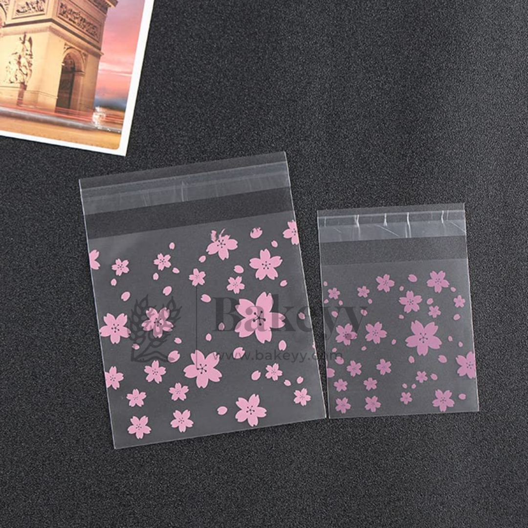 Clear plastic bags with pink floral design on a black surface