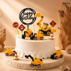 Birthday cake with construction-themed decorations including toy trucks and traffic signs on a beige background.