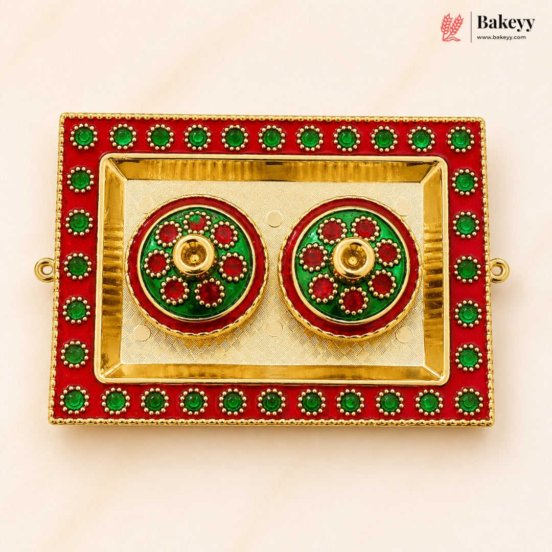 Decorative earrings in a red and gold box with green accents, branded 'Bakeyy'.