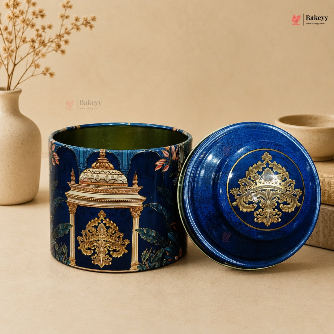 Decorative blue ceramic container with intricate gold patterns on a beige background