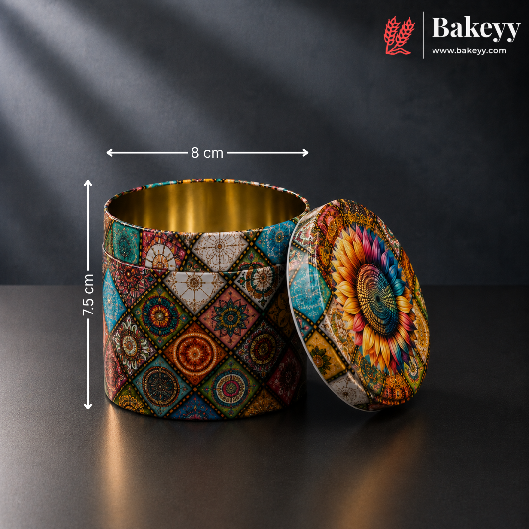 A round metal tin container with a colorful geometric and floral mandala pattern, shown open with its lid leaning against it. White dimension lines indicate a height of 7.