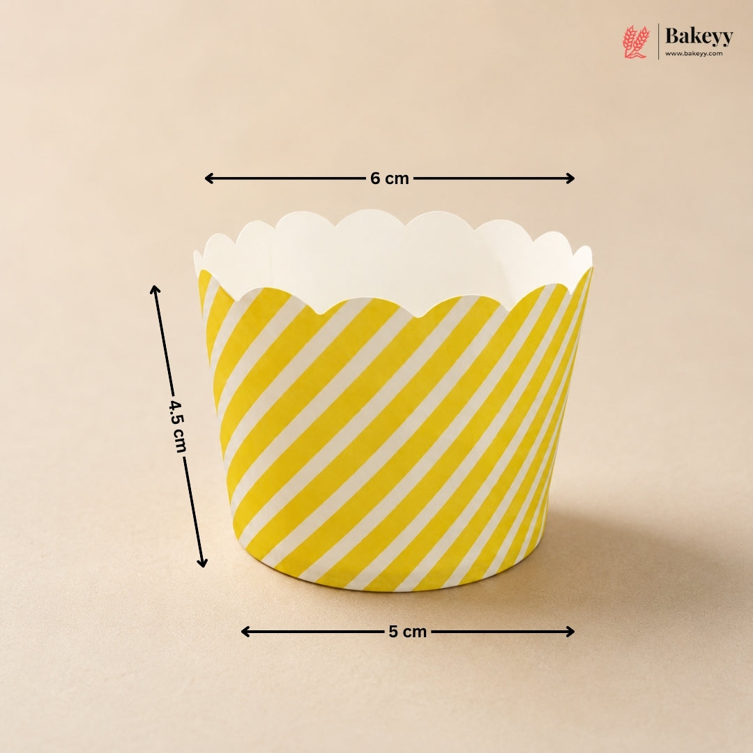 Yellow and white striped cupcake liner with dimensions on a beige background, featuring the Bakey brand.