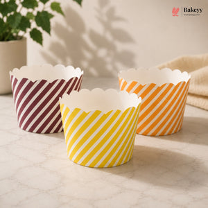 Three striped paper cups on a marble surface with a plant in the background, featuring the Bakey brand.
