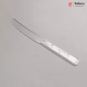 A clear plastic butter knife with a serrated blade and a textured handle, shown diagonally on a light gray background with Bakeyy branding.