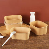 Set of brown rectangular containers with lids on a wooden surface.