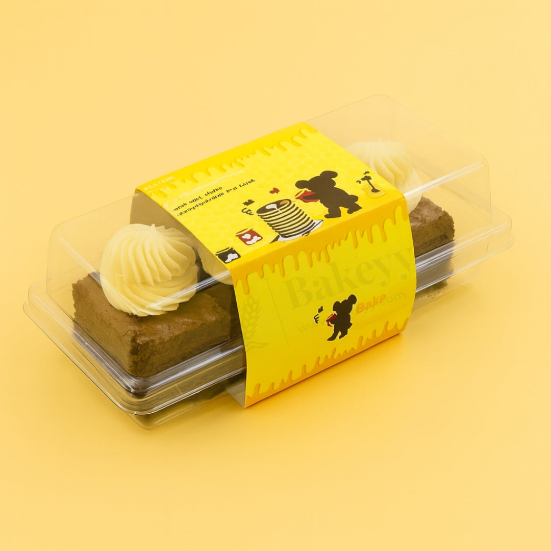 Two brownies in a yellow box with cartoon designs on a yellow background