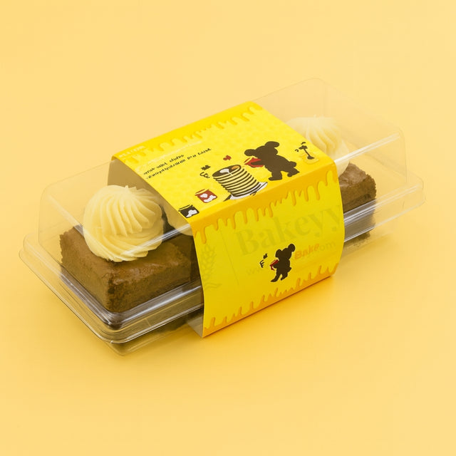 Two brownies in a yellow box with cartoon designs on a yellow background