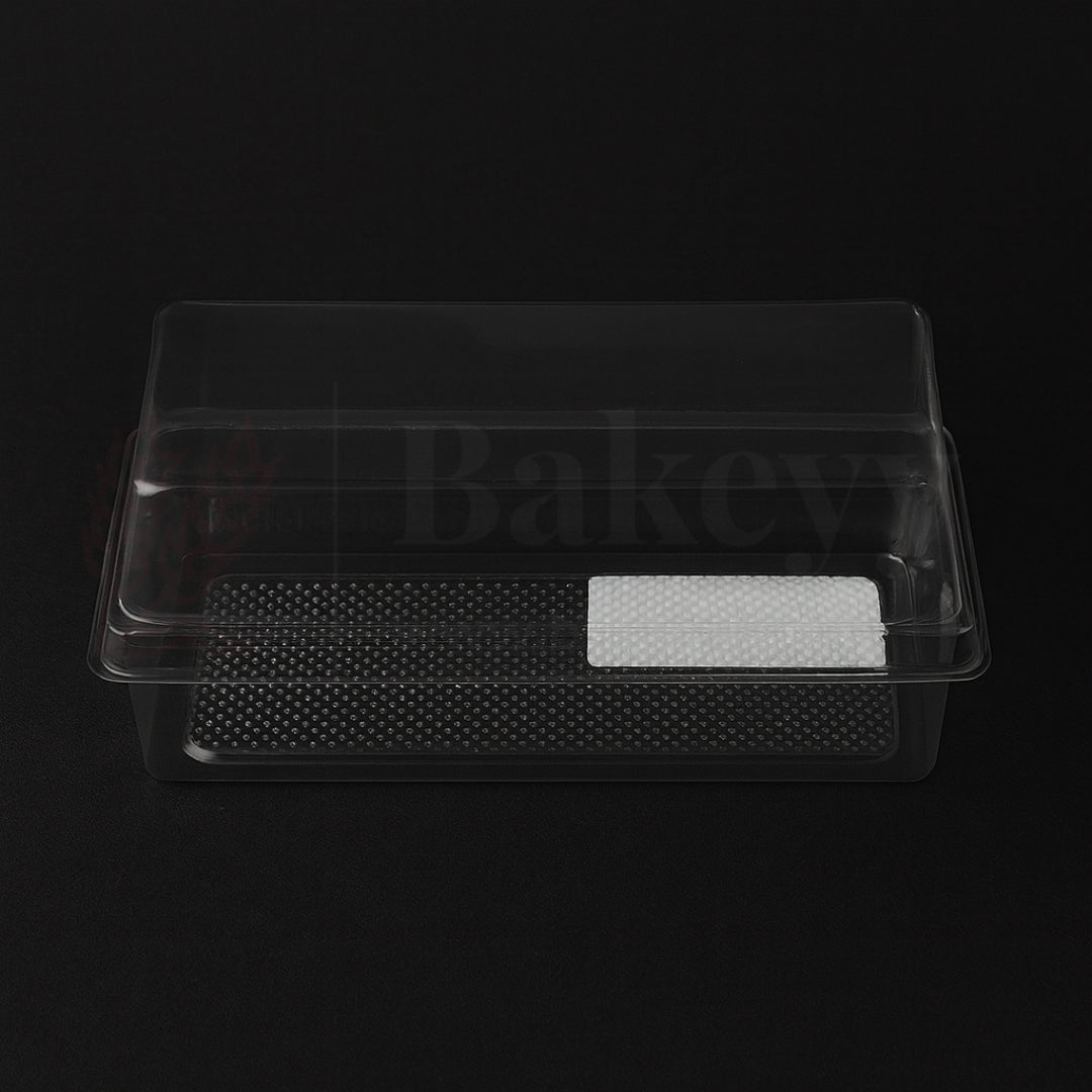 Clear plastic food container with textured base on a black background