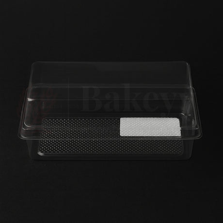 Clear plastic food container with textured base on a black background