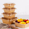 Set of wooden food containers with a smaller container filled with fruits on a light background