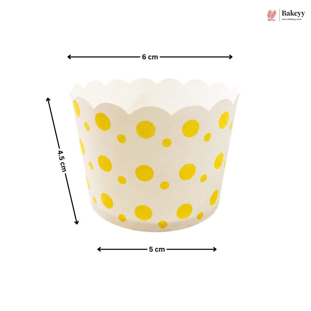 Yellow polka dot cupcake liner with dimensions on a white background