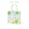 Small green floral gift bag with decorative elements on a white background