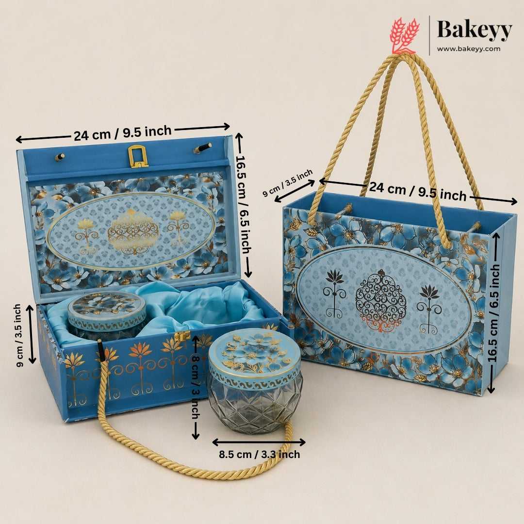 Blue decorative gift packaging set including an open presentation box, a matching tote bag, and a small cylindrical box, shown with rope handles and overlaid dimension arrows. The Bakeyy logo appears in the top right.