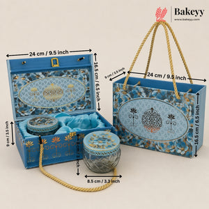 Blue decorative gift packaging set including an open presentation box, a matching tote bag, and a small cylindrical box, shown with rope handles and overlaid dimension arrows. The Bakeyy logo appears in the top right.