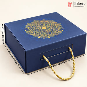 A dark blue rectangular gift box with a gold mandala design on the lid and a gold rope handle, shown with dimension lines indicating 28.5 cm by 30.
