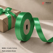 A roll of shiny green satin ribbon with a matching ribbon bow on a brown kraft paper gift box, shown on a beige background with text indicating width and pack size.