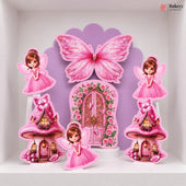 A set of pink fairy-themed party decorations displayed on a white shelf, including a large butterfly, a floral fairy door, two mushroom houses, and two fairy cutouts.