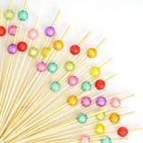 Colorful fancy toothpicks with decorative beads on bamboo sticks for baking and parties, Bakeyy