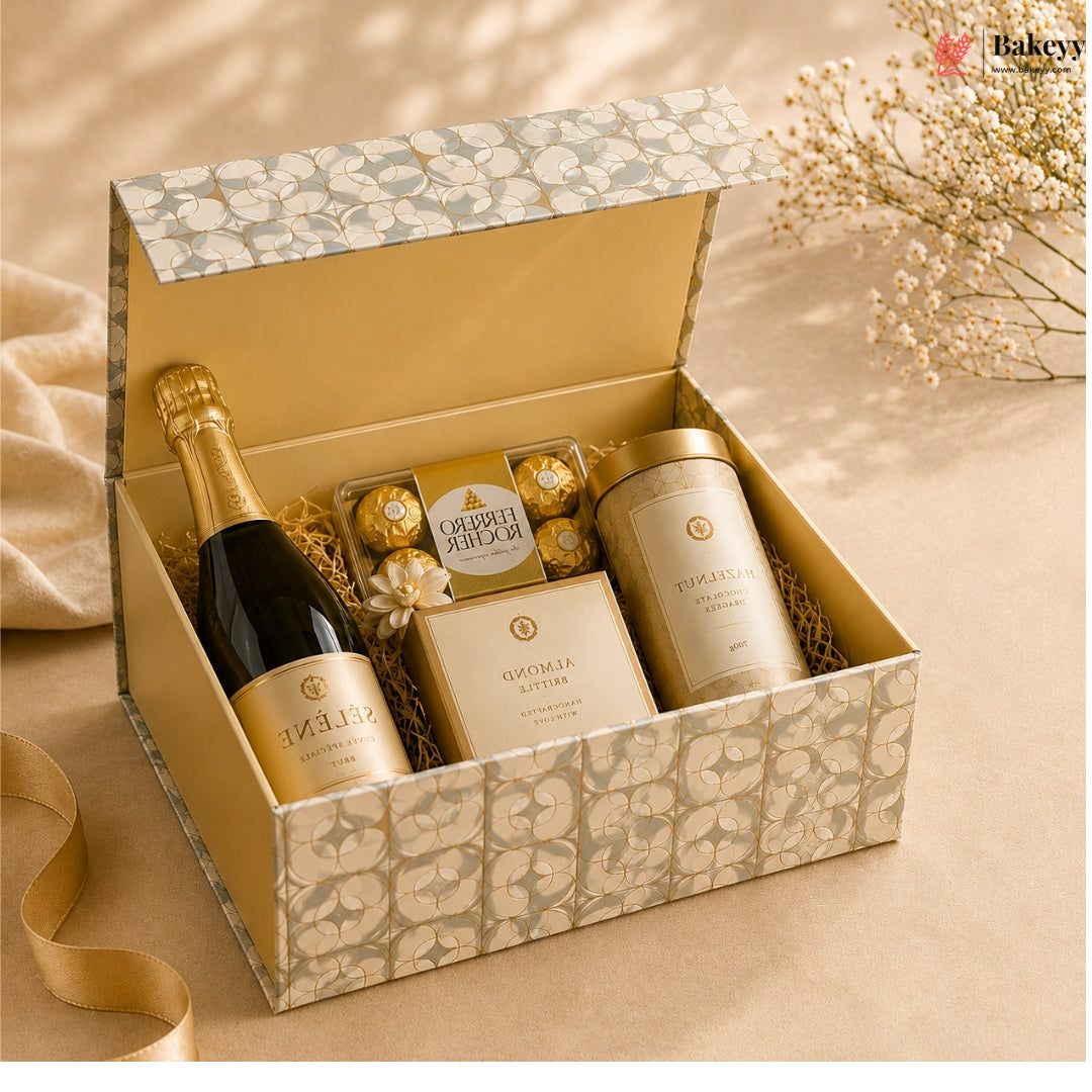 Gift box with champagne, cookies, and a candle on a beige surface