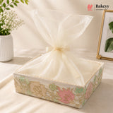 Decorative box with sheer cover and floral design on a light background