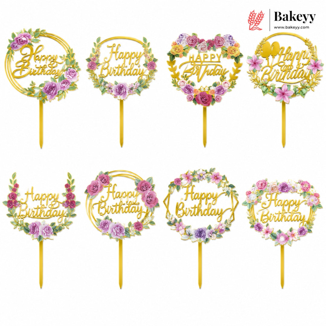 Set of 'Happy Birthday' cake toppers with floral designs on sticks, branded 'Bakeyy'.