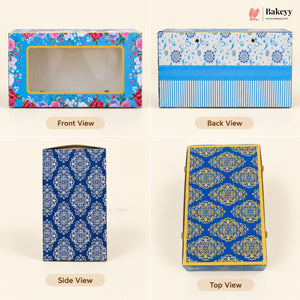 A four-panel product view of a decorative rectangular bakery box on a light beige background. The box has floral and blue patterned printing with gold trim and a clear front window.