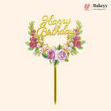 Decorative 'Happy Birthday' cake topper with floral elements on a beige background, featuring the brand 'Bakeyy'.
