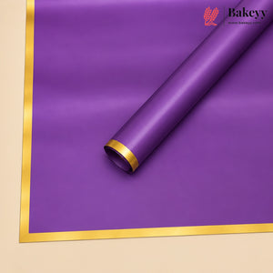 A roll of purple bakery wrapping paper with a metallic gold border, shown partially unrolled on a light beige background. The Bakeyy brand logo is visible in the top right corner.