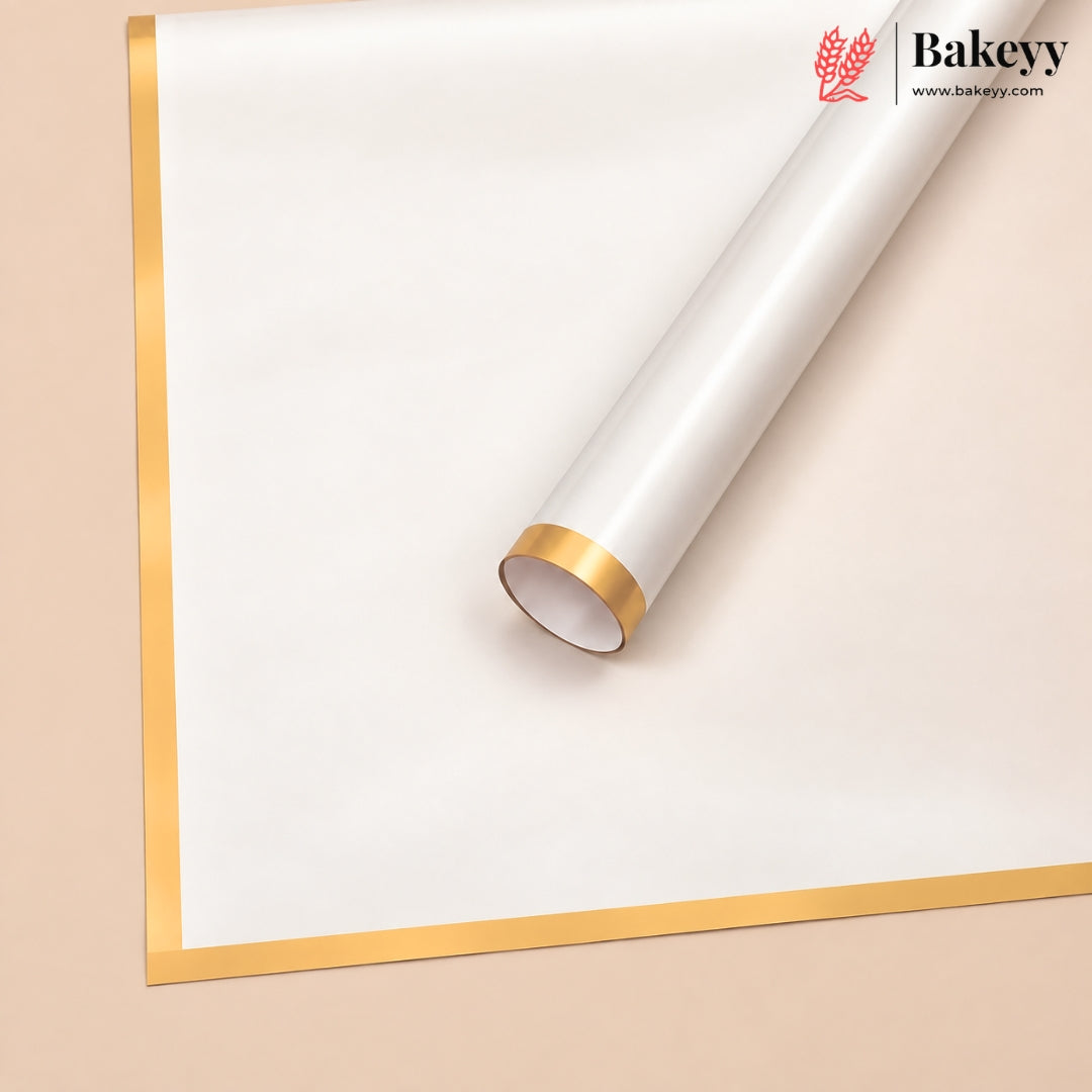 A roll of white bakery wrapping paper or parchment with a metallic gold border, shown partially unrolled on a light beige background. The Bakeey brand logo is visible in the top right corner.