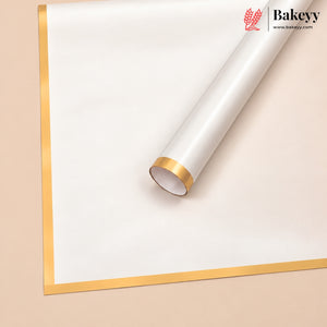 A roll of white bakery wrapping paper or parchment with a metallic gold border, shown partially unrolled on a light beige background. The Bakeey brand logo is visible in the top right corner.