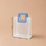 White paper bag with a blue handle and measurements on a beige background