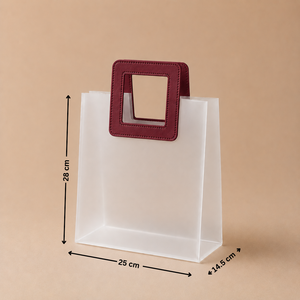 White paper bag with a red handle and measurements on a beige background