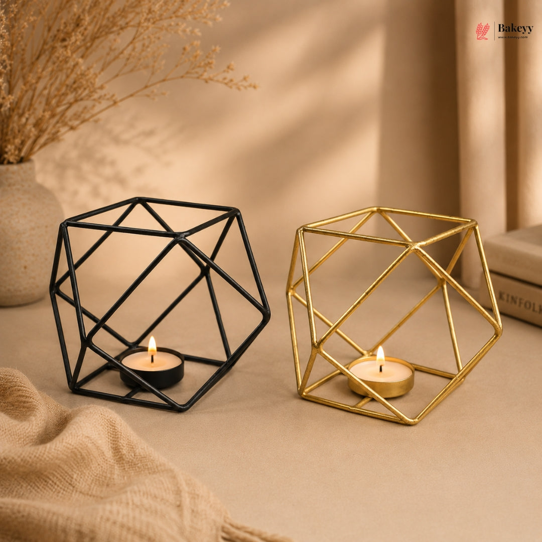 Geometric candle holders, one black and one gold, on a neutral background with candles inside.