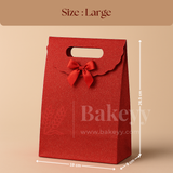 Red gift bag with a bow and measurements on a beige background, featuring the brand 'Bakeyy'.