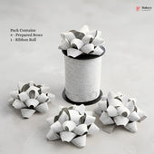 Bakey packaging with prepared bows and a ribbon roll on a light gray background
