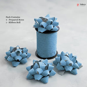 Blue glittery gift bows with a ribbon roll on a light gray background, featuring the Bakeyy brand.