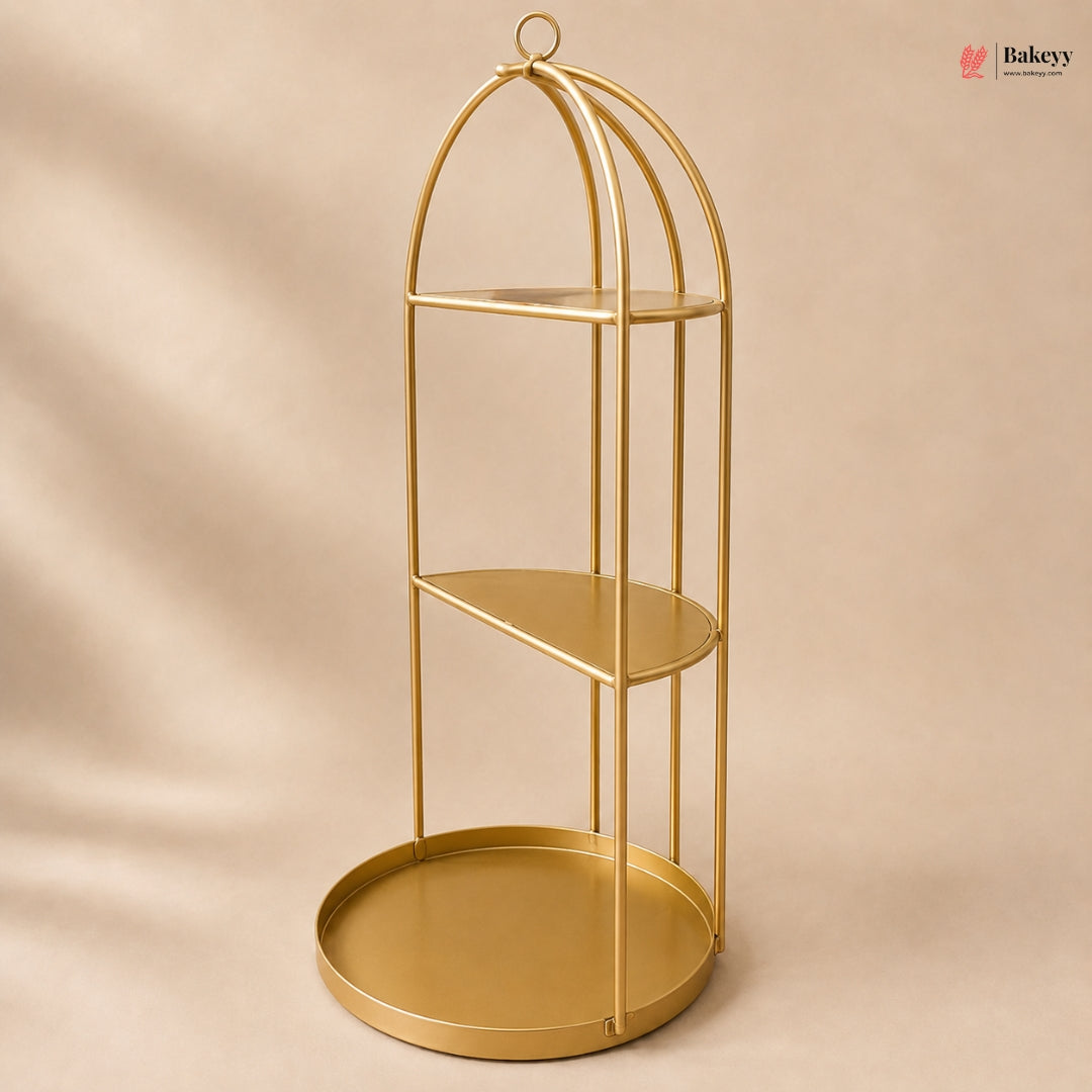Gold metal shelf with three tiers on a beige background