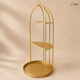 Gold metal shelf with three tiers on a beige background