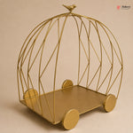 Gold wire birdcage-shaped shelf on a beige background
