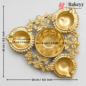 Gold-colored decorative diya holder with four small oil lamps and a central lamp, shown with dimension markings indicating 16 cm by 16 cm and center 6 cm.