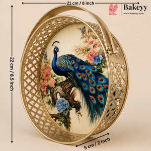 An oval decorative tray with a gold-tone metal frame and a central printed illustration of a peacock surrounded by flowers. Black measurement arrows and labels indicate the tray's dimensions: 22 cm height, 21 cm width, and 5 cm depth, on a beige background.