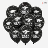 Black balloons with 'Congratulations Grad' text and graduation caps on a white background