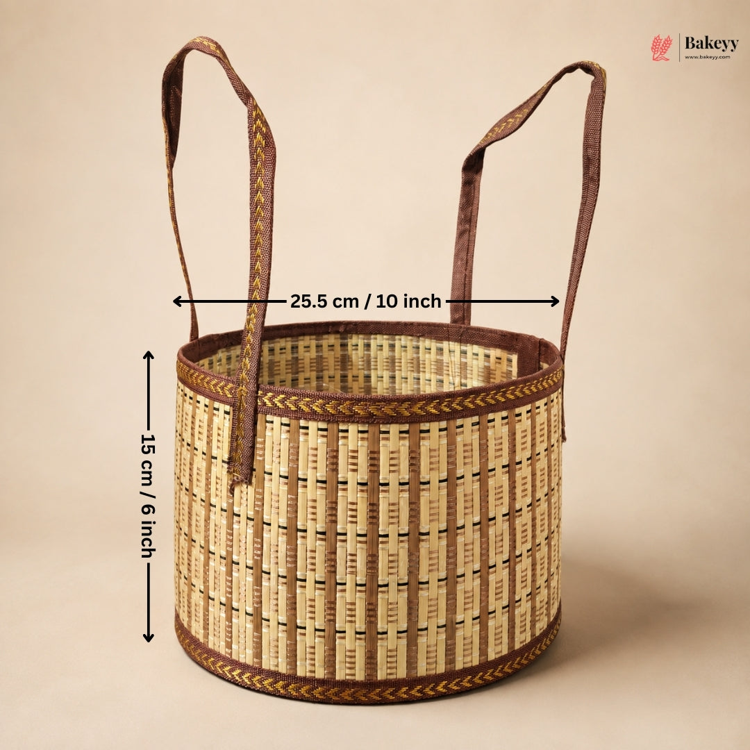 A woven round basket with two handles, shown on a plain beige background with overlaid dimension arrows and text indicating 25.5 cm / 10 inch width and 15 cm / 6 inch height.